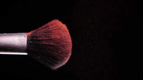 Make Up Brush with Colored Red Powder at Black Background Slow Motion