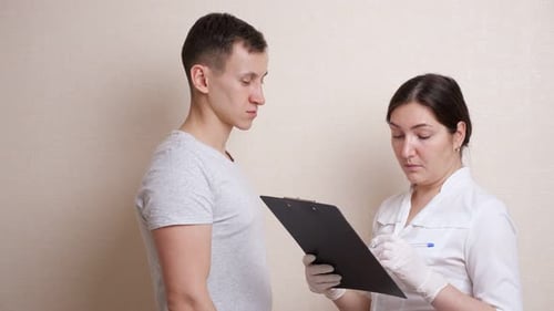 Medical Professional Examining a Patient in Clinic