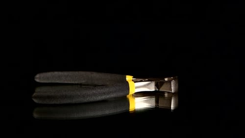 Rotating Silver Pliers with Black and Yellow Handles