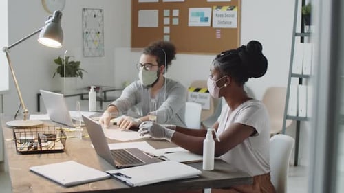 Colleagues in Masks and Gloves Working in Office during Pandemic