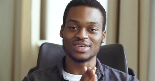 Friendly Man Talking and Gesturing in an Interview Setting