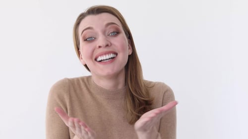 Excited Woman Clapping And Smiling Indoors