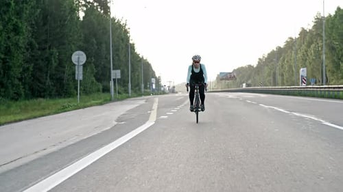 Female Cyclist Training on Highway