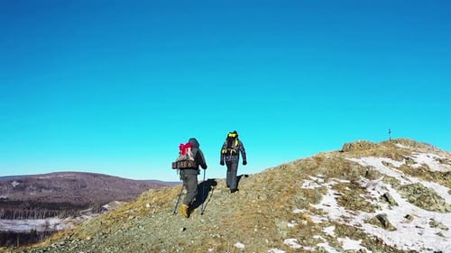 Hiking Concept a Couple of Hikers Walks Along the Mountain Rib