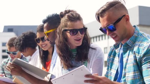 Group of Happy Students with Notebooks at Campus