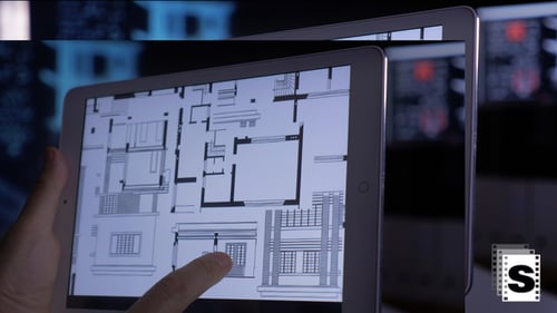 Architect Designs House Using Tablet at Night