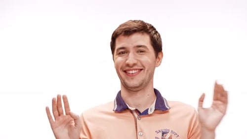 Young Man Smiling Pointing at Himself Refusing Over White Background