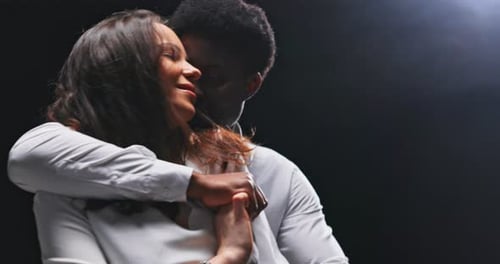 Young Adults in a Loving Embrace in Studio