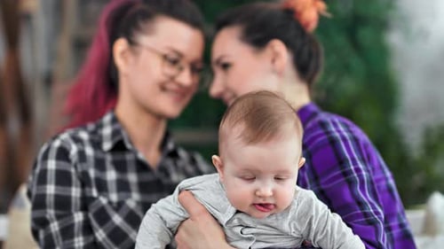 Loving Women and Smiling Infant Together Indoors
