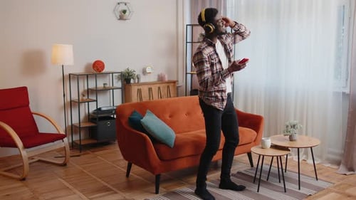 Young Adult Dancing to Music at Home