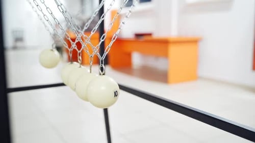 Newton's cradle showing laws of physics in motion. Museum of Science