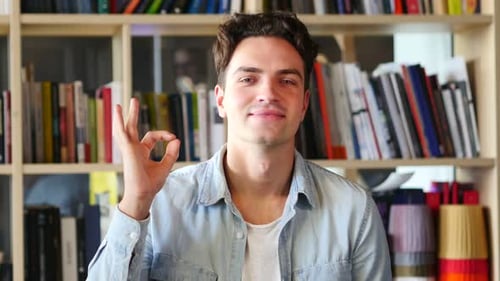 Young Adult Makes OK Hand Gesture