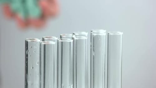 Close Up of Scientist Pouring Blue Acid Into Test Tube