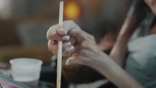 Woman Holding Paint Brush Inside