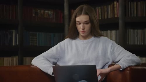 Caucasian Woman Student Working on a Laptop Confused