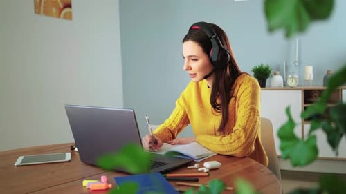 Woman Studies Online with Laptop and Headphones