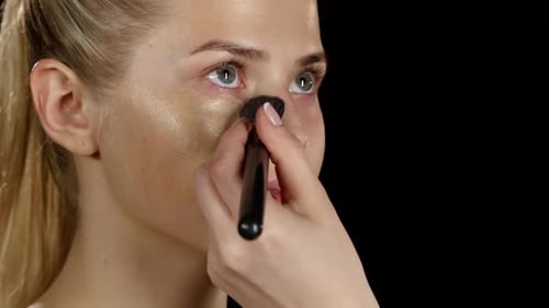 Applying Foundation with Makeup Brush on Woman's Face