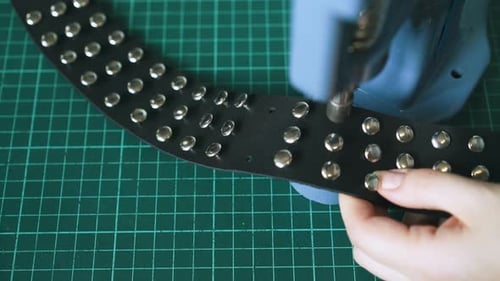 Hand Applying Metal Studs With Press Machine