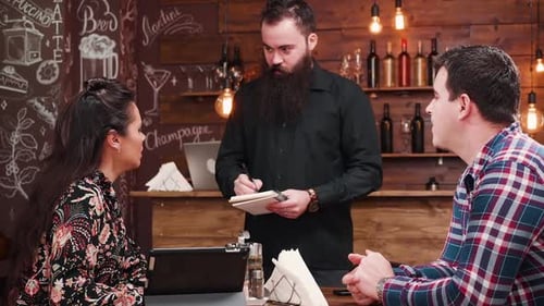 Couple Ordering Food in a Cozy Restaurant