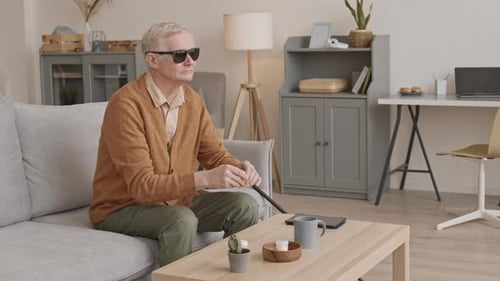 Blind Elderly Man Taking Pills at Home