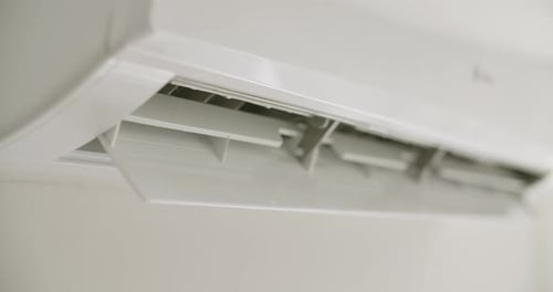 Modern Air Conditioner on White Wall, Close Up