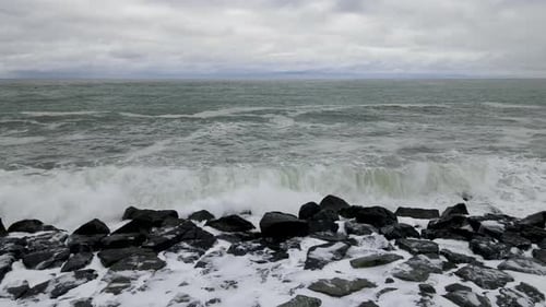 Ocean Waves Crashing onto Rocky Shoreline