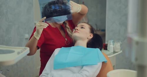 Young Pretty Girl at the Reception at the Dentist in a Modernly Equipped Clinic