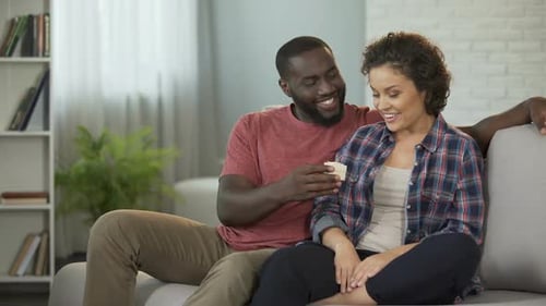 Loving Couple Celebrating Engagement in Home Setting