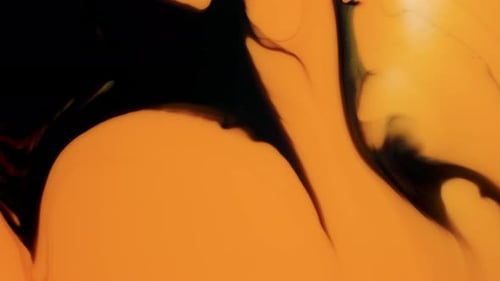 Hypnotic Ink Flowing Over Amber Background