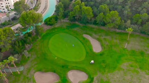 Aerial View. Golfer on a Vibrant Green Course.