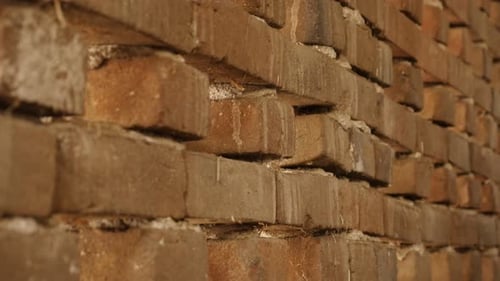 Tilting on old bricks headers and stretchers close-up 4K 2160p 30fps UltraHD footage - Weathered ho