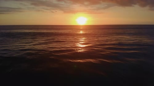 Flight at Sunset Overlooking the Indian Ocean in Bali Indonesia