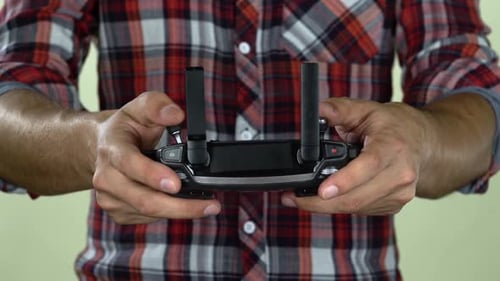 Man in a Controls the Remote Control From the Computer. Close Up