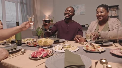 Family and Friends Toasting at Dinner Table
