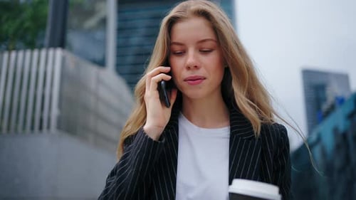 Business Woman Speaking Mobile Phone Onthe Go to Office Outdoors