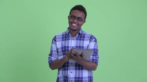 Young Adult Using Tablet Smiling in Studio