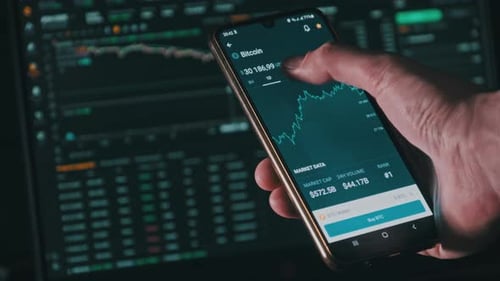 Analyzing Bitcoin Chart on Mobile Phone