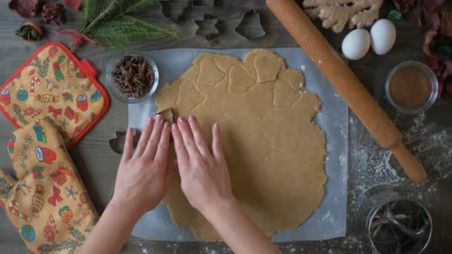 Top View of a Woman's Hand Making a Gingerbread Cookie. Christmas and New Year Concept
