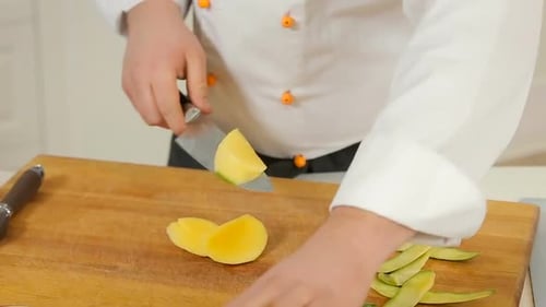 Chef Dicing a Fresh Mango in Kitchen