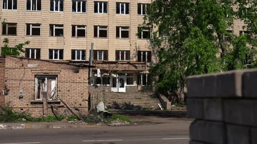 Summer Day in Kiev Ukraine with Bombed Ruined Residential Building at Background