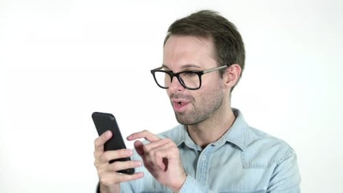 Man Celebrates Good News on Mobile Phone