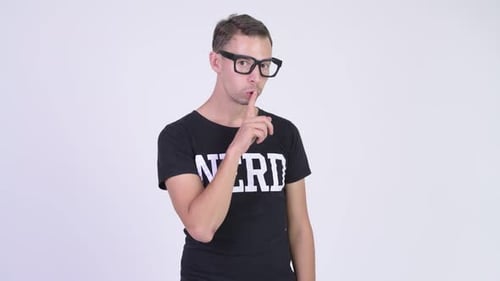 Studio Shot of Happy Nerd Man with Finger on Lips
