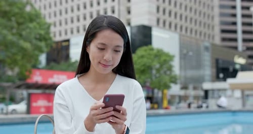 Woman use of mobile phone in city
