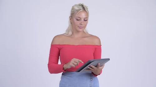 Happy Young Beautiful Blonde Woman Thinking While Using Digital Tablet