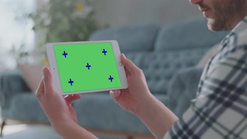 Man Using Digital Tablet with Green Screen