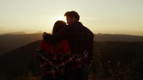 Romantic Couple Embracing at Sunset in Mountains