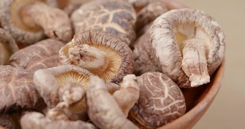 Close Up of Shiitake Mushrooms in Wooden Bowl