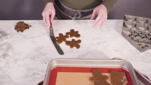 Making Christmas gingerbread cookies on marble table