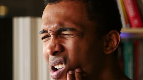 Man Experiencing Jaw Pain in Close Up