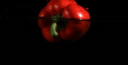 Vibrant Red Bell Pepper Floating in Clear Water